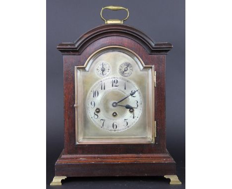 An early 20th century walnut bracket clock, with silvered Arabic numeral chapter ring below silent/chime and speed selectors,