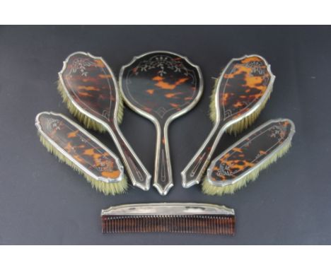 A six piece silver and tortoiseshell backed dressing table set, C & A, London 1920, each piece with inset floral wire work de