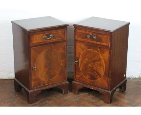 Three reproduction mahogany bedside cupboards, each with a drawer and cupboard door on bracket feet, 67cm x 40cm x 34cm; with