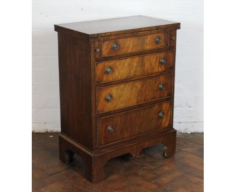 A reproduction mahogany bachelors type chest, with fold over top above four graduated long drawers, on bracket feet, 80cm x 7