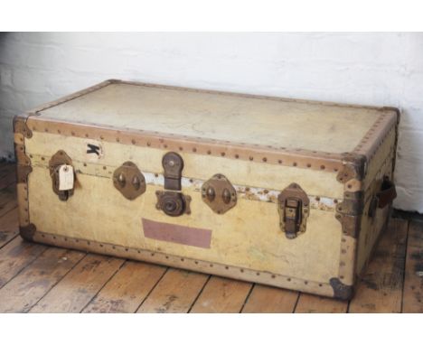 A vintage vellum bound travelling trunk, with brass hinges and corner mounts and lined interior, 35cm x 91cm x 53cm