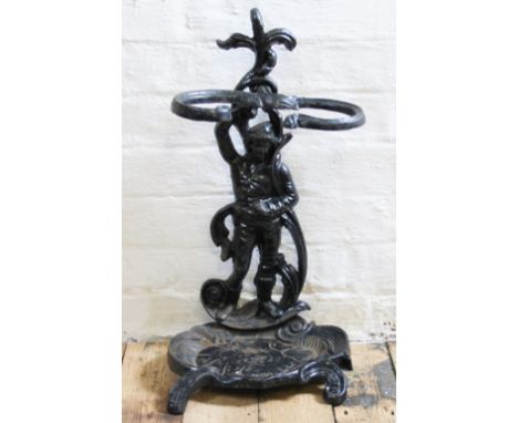 A late Victorian cast iron stick stand, modelled as a Gentleman standing beside a pond, 59cm