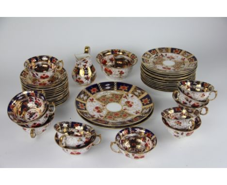 A twelve piece Royal Crown Derby style imari tea service, comprising; milk jug, sugar bowl, 12 tea cups, 12 saucers, 12 sidep