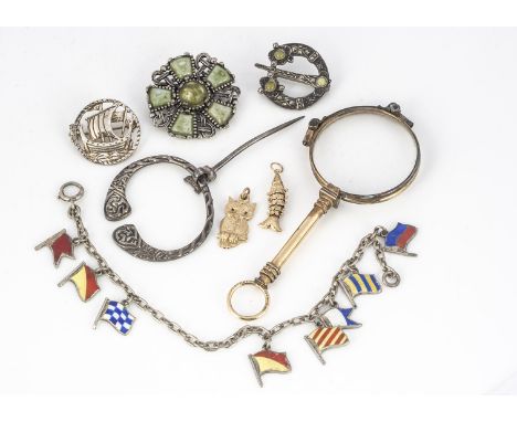 A silver Celtic Plaid brooch, with Glasgow hallmarks for 1950, a Viking brooch, two gold charms in 9ct, a pair of Lorgnettes,