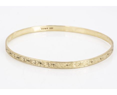 A 9ct gold bangle, of oval design, with engraved exterior, 7 cm by 6.6 cm 10g