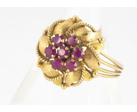 A continental yellow metal 18k ruby cluster ring, leaf design, with beaded decoration and banded shank, marked 18K N1/2, 2.6g