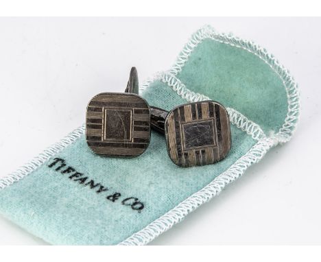 A pair of silver 'Tiffany &amp; Co' cufflinks, the cushion shaped fronts with engine turned design, post backs marked to bar 