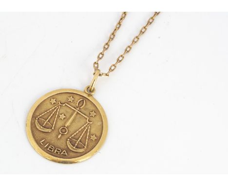 A continental yellow metal Libra pendant and chain, circular medallion marked to reverse, 18k 750, chain rectangular links ma