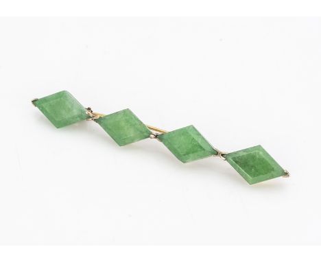 A Chinese jadeite jade four panel brooch, the lozenge shaped panels in a yellow metal mount, 5.5 cm by 0.5 cm 3g