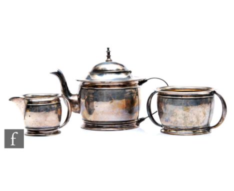 An Edwardian silver three-piece solitaire tea service, comprising a teapot, a twin handled sugar basin and a milk jug, weight