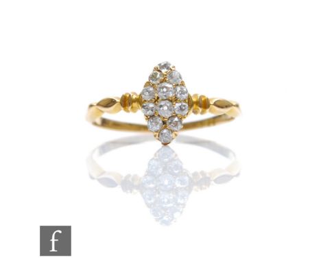 An early 20th Century diamond marquise shaped cluster ring comprising twelve stones to ribbed shoulders, weight 1.8g, ring si