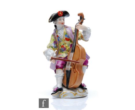 A 19th Century model of the cello player from the Gallant Orchestra, after the original by J.J Kandler, seated with a yellow 