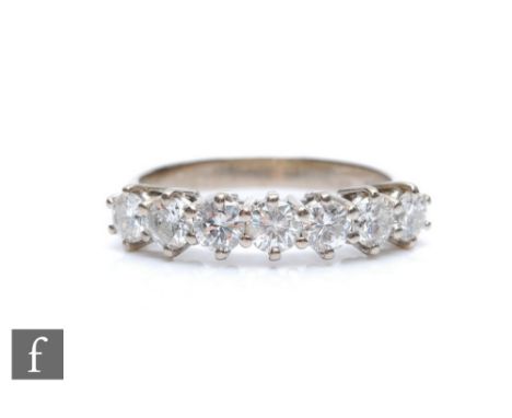 An 18ct white gold diamond half eternity ring, seven brilliant cut claw set stones, total weight approximately 1.40ct, weight
