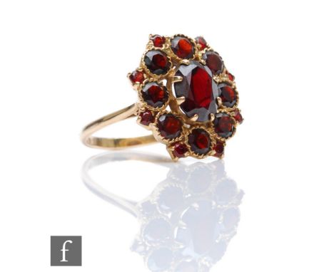 A 9ct hallmarked garnet cluster ring, comprising claw and collar set stones, weight 4.9g, ring size N. 
