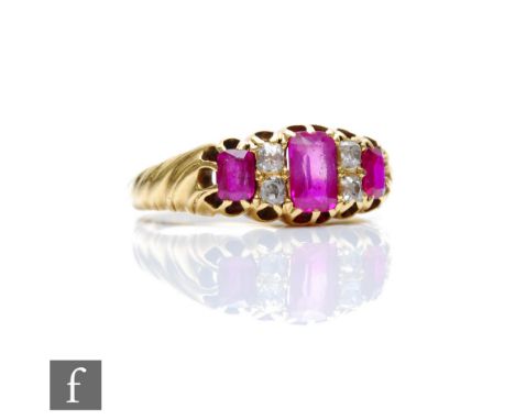 An early 20th Century ruby and diamond seven stone boat shaped ring, three rubies spaced by diamonds, weight 3.8g, ring size 