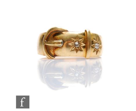 An early 20th Century 18ct buckle ring detailed with two gypsy set diamonds, weight 6.8g, ring size M, stamped 18ct. 