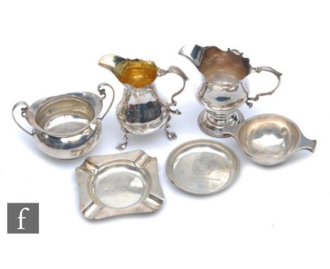 Two George III cream jugs, marks rubbed, a sugar basin, an engine turned ash tray, a small circular ash tray, a small sugar b