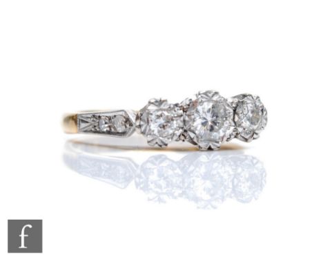 An 18ct diamond three stone ring, illusion set brilliant cut stones to diamond set shoulders, weight 3g, ring size M. 