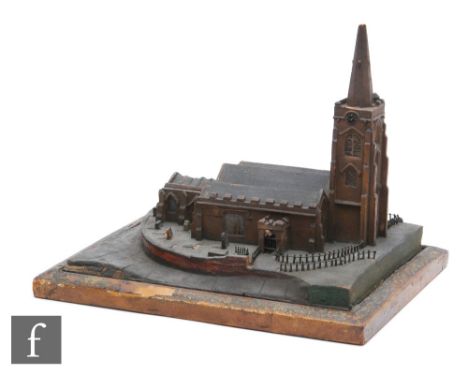 A 19th Century scale wooden model of a church with steeple, on a fenced board with grave stones, width 32cm, damaged. 