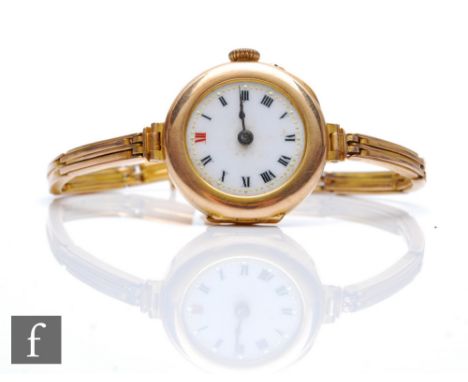 An early 20th Century 9ct hallmarked manual wind wrist watch, Roman numerals to a white enamelled dial to a 9ct sprung bracel