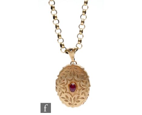 A 9ct hallmarked oval locket with central cabochon cut collar set ruby suspended from a 9ct belcher link chain, total weight 