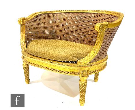 An early 20th Century Louis XVI style child's bergere salon sofa, with acanthus carved gilded frame and double bergere canewo