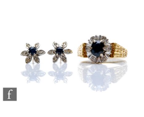 A gold sapphire and diamond cluster dress ring and a pair of matching flower head ear studs. (3) 