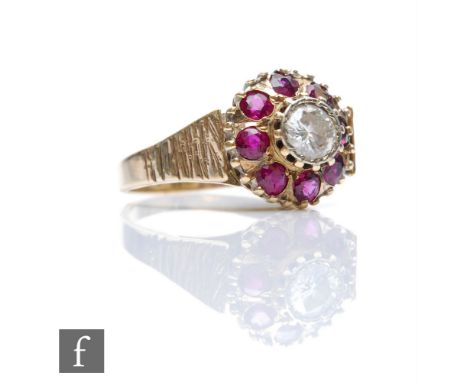 A mid 20th Century ruby and diamond cluster ring, central brilliant cut diamond, weight approximately 0.50ct, within a border