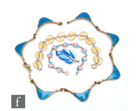 Four pieces of enamel jewellery comprising a bracelet formed from yellow leaves, a blue leaf brooch, a bracelet formed from p