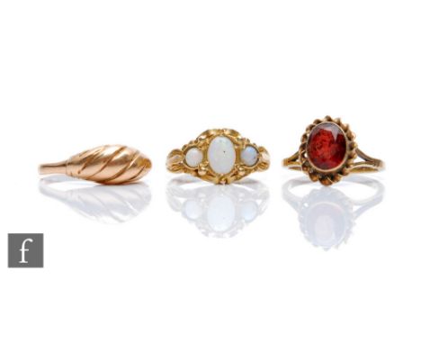 Three 9ct rings to include a three stone opal and a single stone garnet example, total weight 7.5g, various styles and dates.