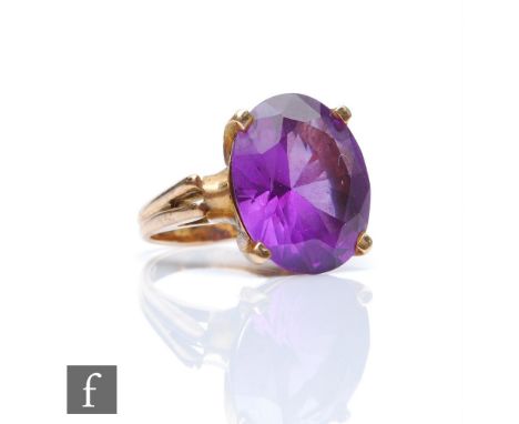 A 14k gold dress ring set with a facet cut amethyst coloured stone in a claw setting. 