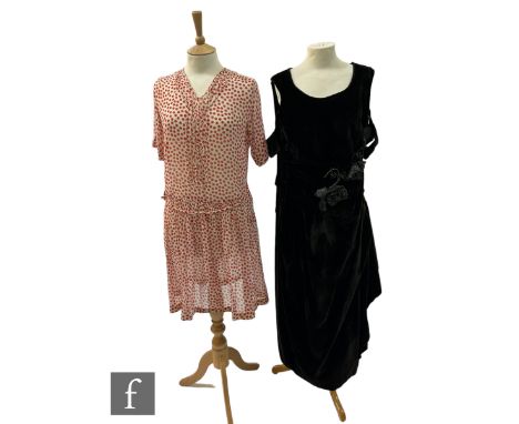 A 1920s muslin flapper day dress with red dot pattern, and a 1920s French couture black velvet dress with floral corsage, bot