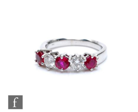 An 18ct white gold ruby and diamond five stone ring, three rubies spaced by diamonds each approximately 0.33ct, all to a plai