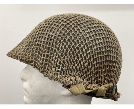 WW2 US M1 Helmet with swivel bale chinstrap. Rear seam. Heat stamp number 117B. Fitted with a postwar Belgian made liner by C