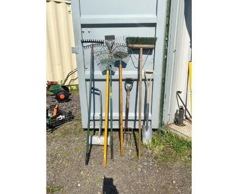 Garden tool set.  Includes: Metal fork.  Metal spade.  Two grass rakes. Yard broom and a leaf collector. Please note this lot