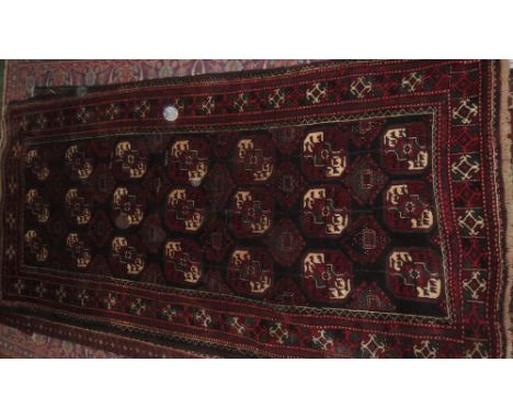 Belouch design carpet, dark blue ground with numerous Bokhara style  motifs