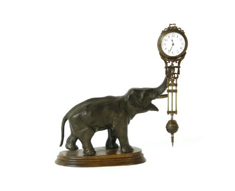 A spelter mystery clock, modelled as an elephant, holding the clock on it's trunk, 28cm high