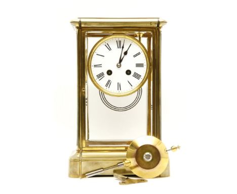 A 19th century four glass brass mantel clock, with white enamel dial and black Roman numerals, the eight day movement strikin