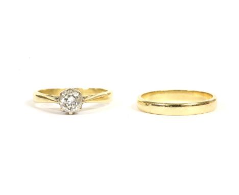 An 18ct gold single stone ring, a brilliant cut diamond, claw set to chenier shoulders to a plain polished shank, 2.67g, size