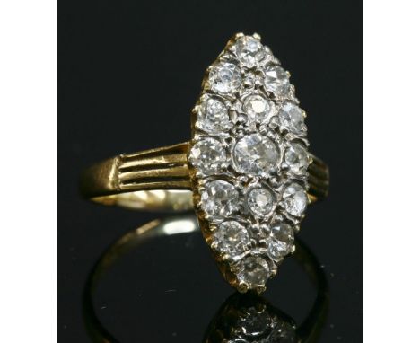 A late Victorian diamond set marquise cluster ring,with graduated old brilliant cut and one brilliant cut diamond, all claw s