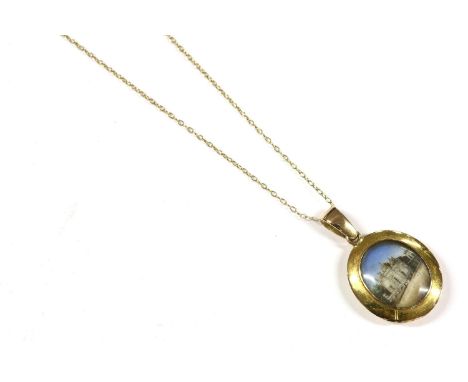 A gold picture locket, with miniature painted scenes of Indian buildings, marked 18ct, suspended on a gold trace chain, (chai