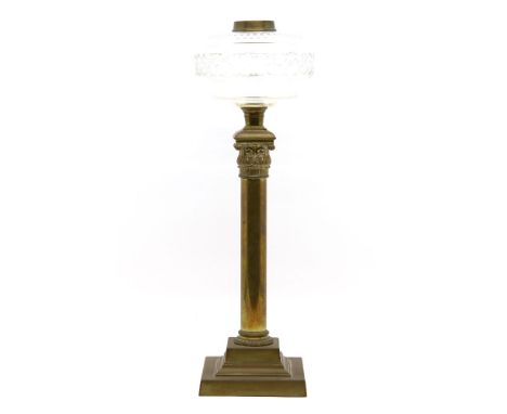 A Victorian brass etched glass oil lamp, the conical shade above clear glass reservoir, raised on central column and stepped 