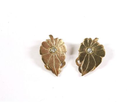 A pair of single stone diamond leaf shaped earrings, with clip on fittings, tested as approximately 9ct gold, 2.84g and a sin