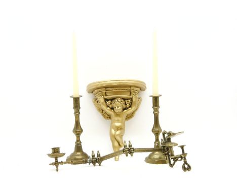 A collection of brass ware, to include candlesticks, a miniature easel, together with glass shades, an ebonised wall mirror w