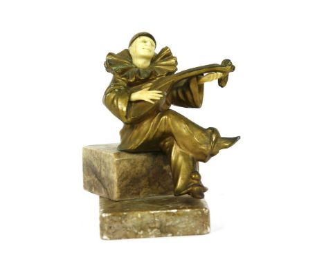 A gilt metal and ivory Pierrot, modelled playing a lute, on a marble plinth, 13.5cm high