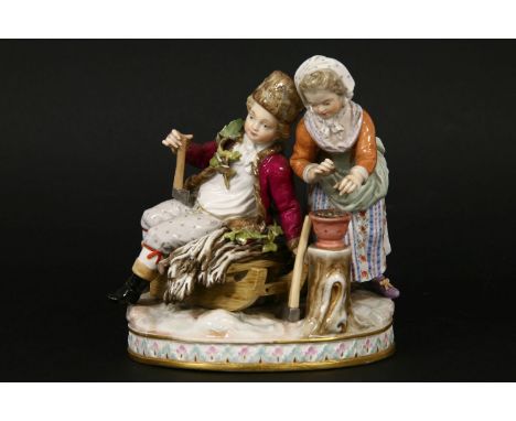 A Meissen group of winter, late 19th century, modelled as a boy seated on a sled with a girl warming her hands by a brazier, 