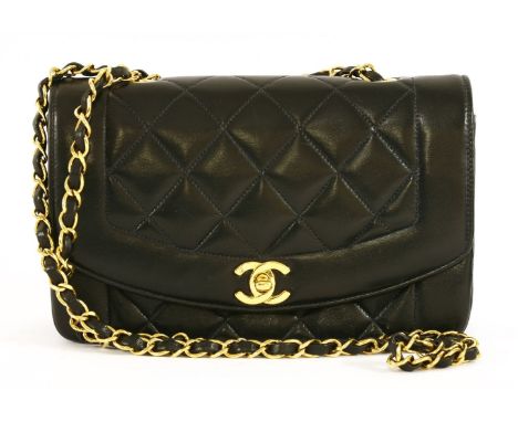A Chanel Classic flap bag, with iconic quilted navy and smooth lambskin leather with gold-tone hardware, single chain and int
