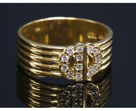 A gold diamond set 'C.D.' ring by Christian Dior,with a row of brilliant cut diamonds, grain set to the initials to a five ro