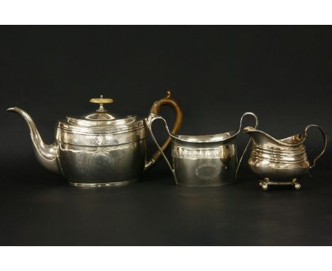 A Georgian silver teapot, 13cm high, a matched sucrier and cream jug