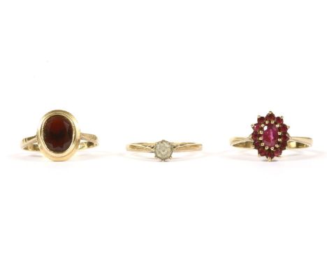 A 9ct gold single stone garnet ring, oval cut, rub set to a plain polished shank, 2.47g, a 9ct gold single stone synthetic sp